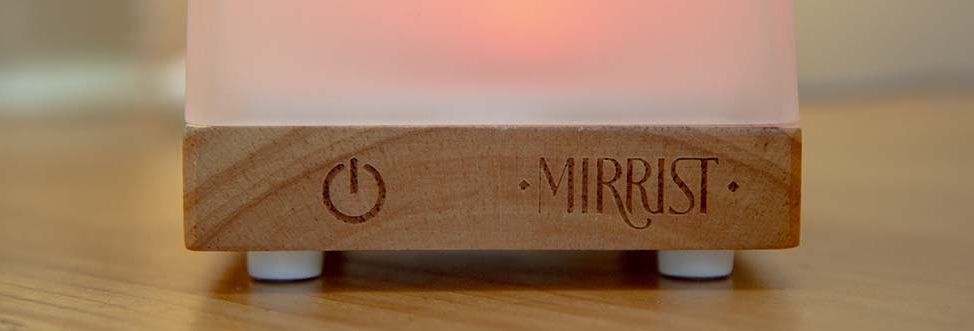 Mirrist closer up image of logo and glass with red light on.